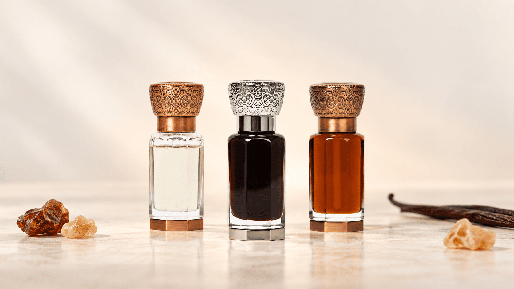 হালকা আইভরি ব্যাকগ্রাউন্ডে AROWA-এর Amber Rose, Amber Oud ও Musk E Amber আতরের বোতল