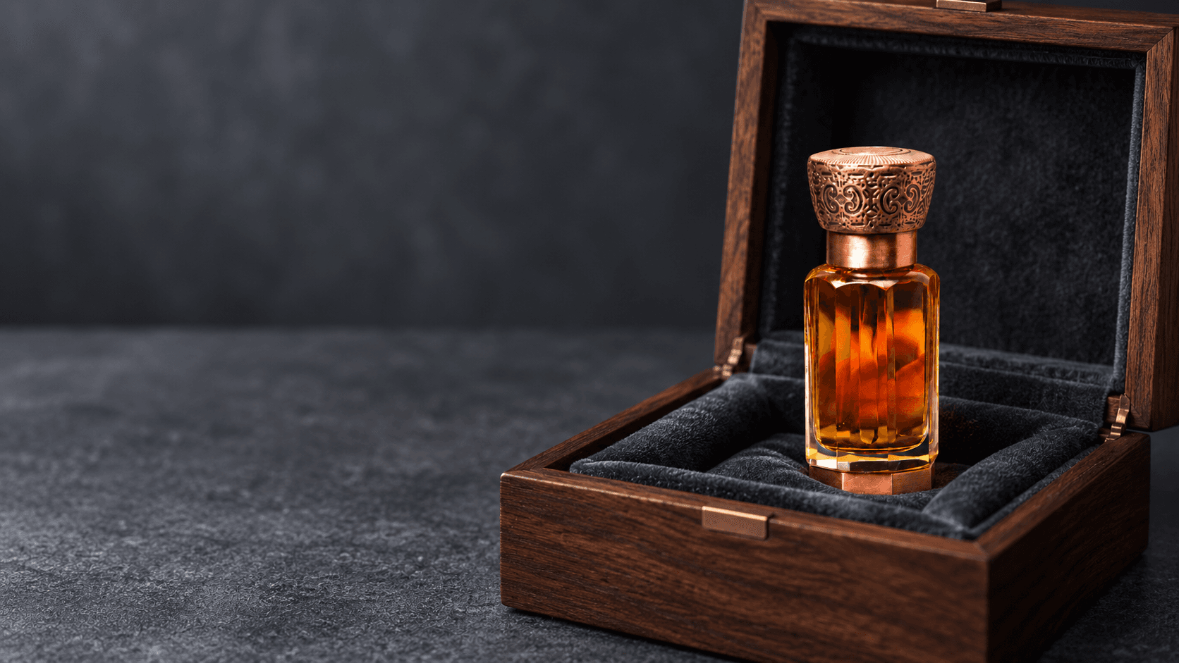 Glass attar bottle stored upright in a dark wooden box